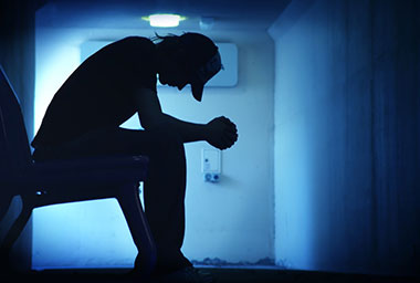 silhouette of a depressed man
